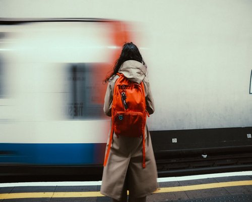 Person commuting by foot near an urban subway station