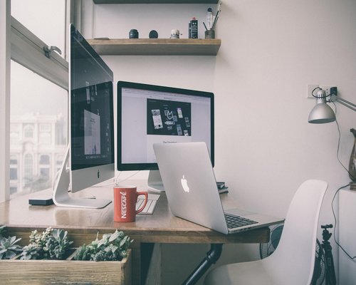 Organized home office desk with natural lighting